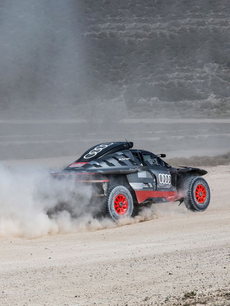 The Audi RS Q e-tron driving on a gravel track.